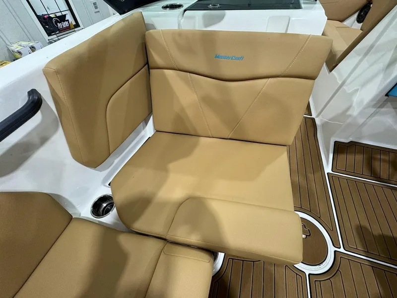 Slide: The Image of 2022 MasterCraft NXT24 boat with tan leather seating and teak flooring. - 11