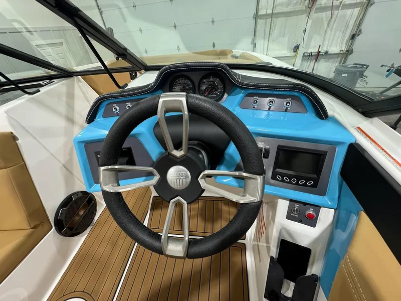 Slide: The Image of 2022 MasterCraft NXT24 boat dashboard with steering wheel and control panel. - 12