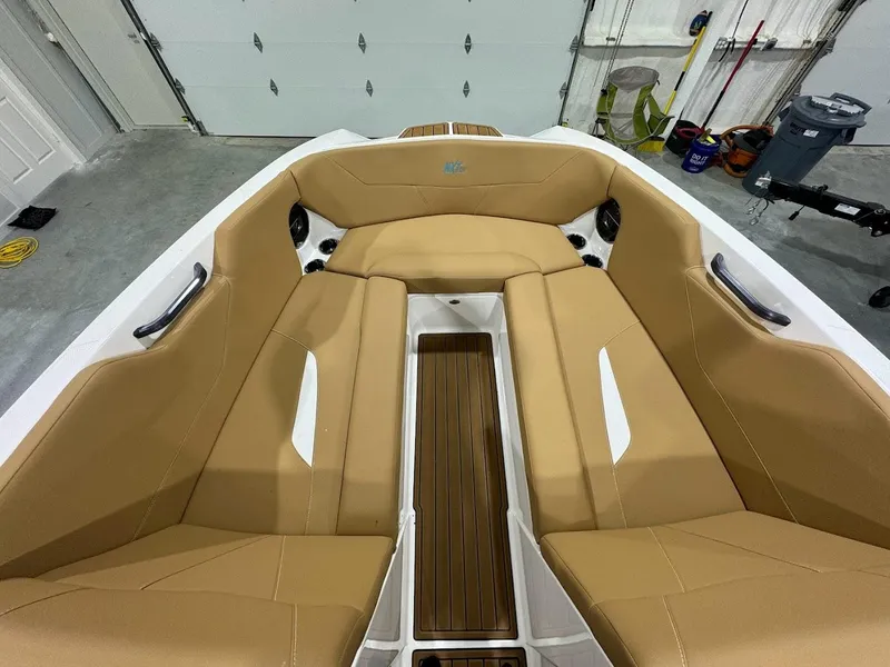 Slide: The Image of 2022 MasterCraft NXT24 boat interior with tan seating and wood accents. - 15