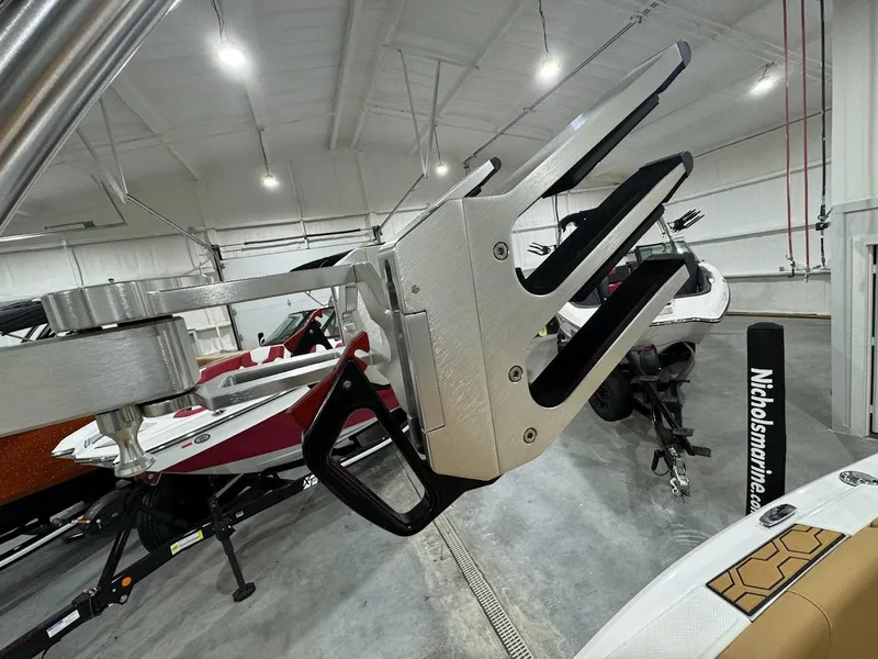 Slide: The Image of 2022 MasterCraft NXT24 boat in showroom, close-up of wakeboard rack. - 17