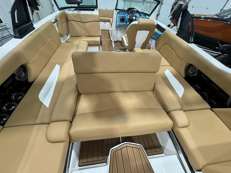 Slide: The Image of 2022 MasterCraft NXT24 boat interior with tan seating and modern dashboard. - 19