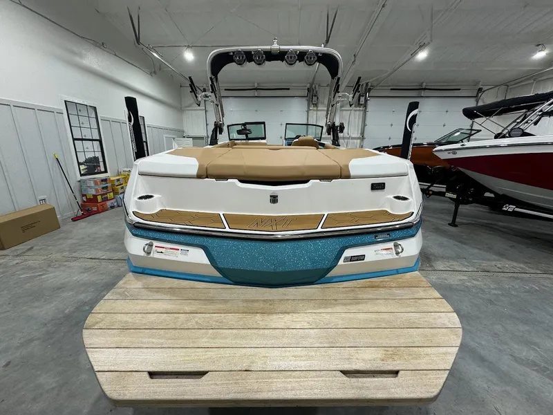 Slide: The Image of 2022 MasterCraft NXT24 boat in showroom, rear view. - 2