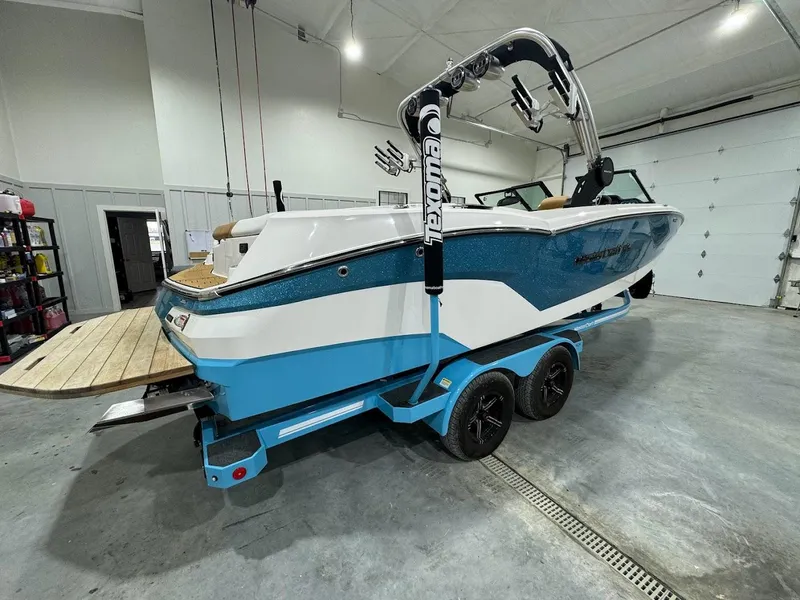 Slide: The Image of 2022 MasterCraft NXT24 boat on trailer in indoor storage. - 4