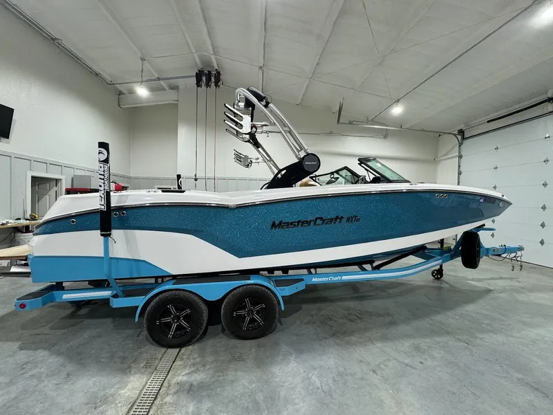 Slide: The Image of 2022 MasterCraft NXT24 boat on trailer in indoor storage. - 5