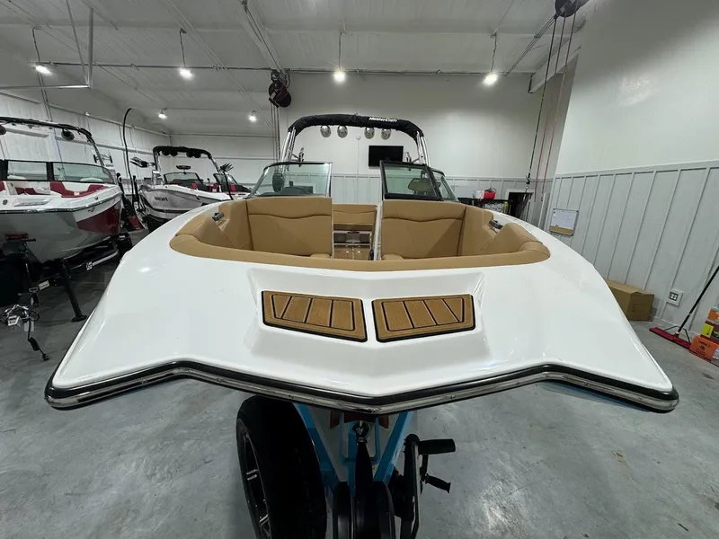 Slide: The Image of 2022 MasterCraft NXT24 boat in showroom, front view. - 7