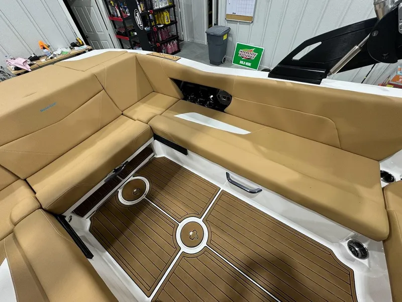 Slide: The Image of 2022 MasterCraft NXT24 boat interior with tan seating and teak flooring. - 9