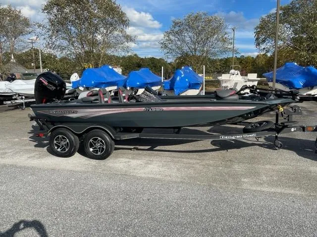 Slide: The Image of 2024 Ranger RT198P fishing boat on a trailer in a parking lot. - 3