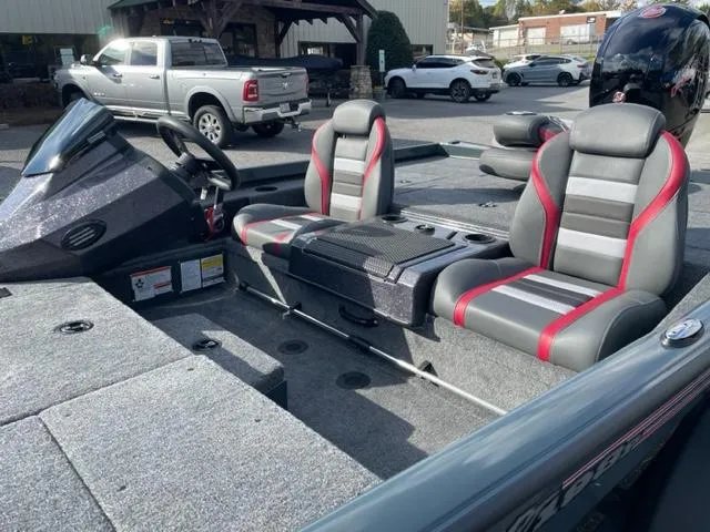 Slide: The Image of 2024 Ranger RT198P boat interior with gray and red seats, steering console, and spacious deck. - 6