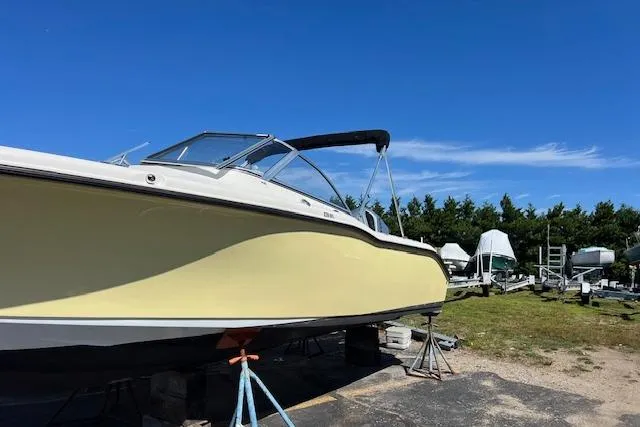 Slide: The Image of 2020 Key West 239 DFS boat on stands under clear blue sky. - 1