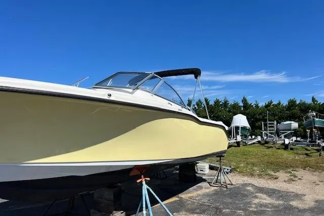 Slide: The Image of 2020 Key West 239 DFS boat on stands under clear blue sky. - 2