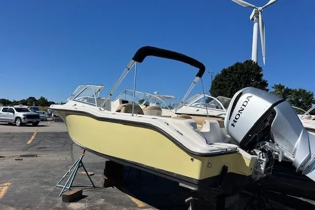Slide: The Image of 2020 Key West 239 DFS boat with Honda outboard motor, parked outdoors. - 5