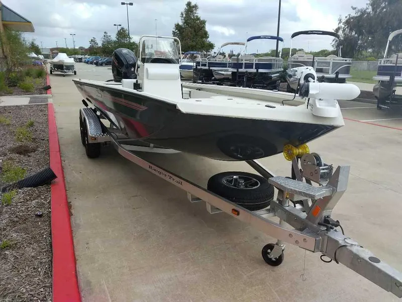 Slide: The Image of 2024 Ranger RB200 boat on trailer in a marina parking lot. - 2