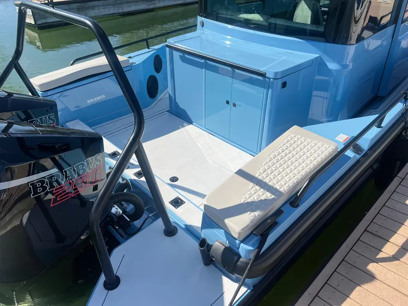 Slide: The Image of 2023 BRABUS Shadow 500 Cabin boat, rear deck view with seating and storage. - 10