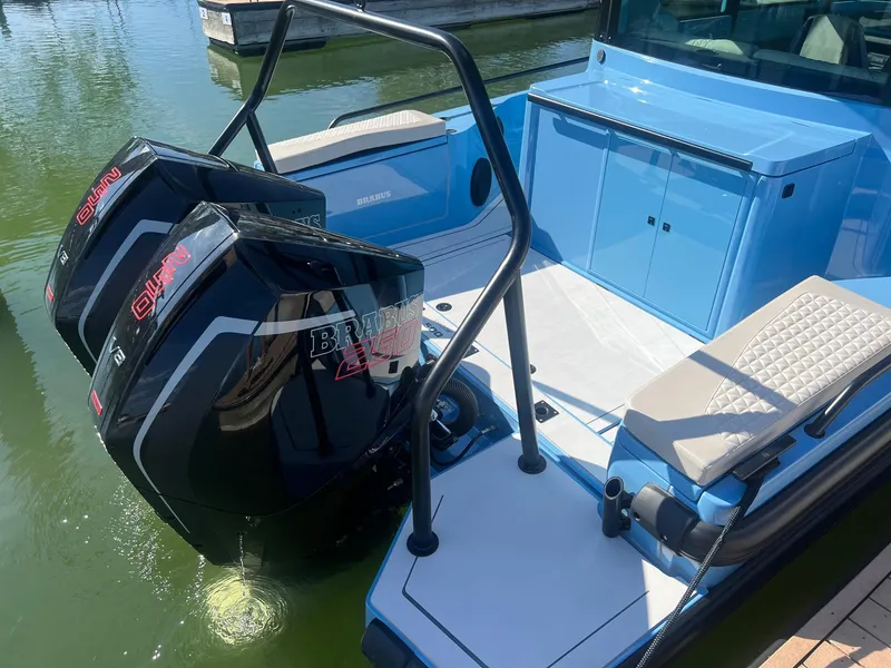 Slide: The Image of 2023 BRABUS Shadow 500 Cabin with dual outboard engines docked on water. - 14