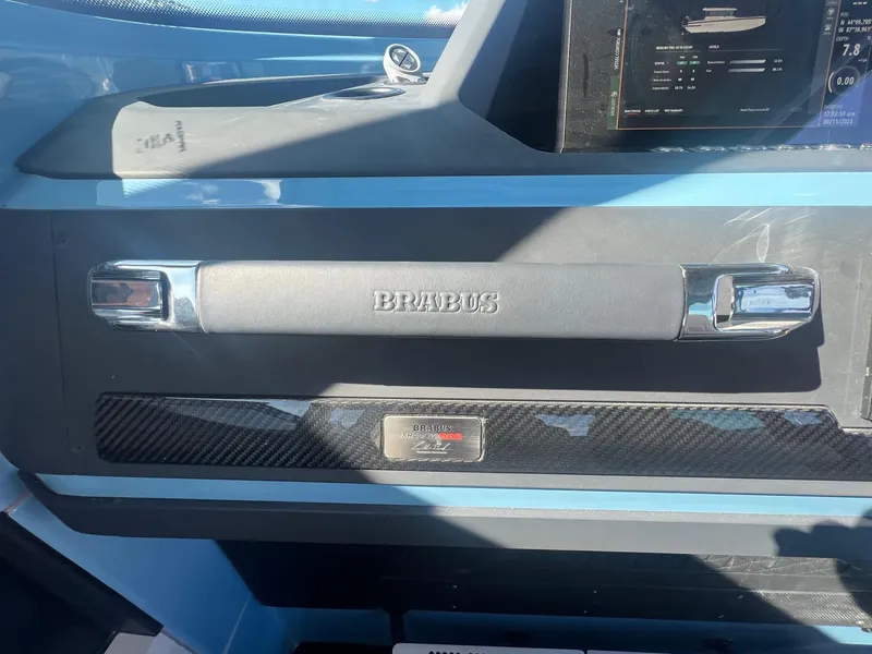Slide: The Image of BRABUS Shadow 500 Cabin 2023 dashboard with carbon fiber accents and branded handle. - 27