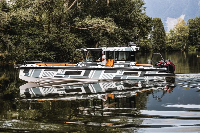 Slide: The Image of 2023 BRABUS Shadow 500 Cabin boat cruising on a serene lake. - 32