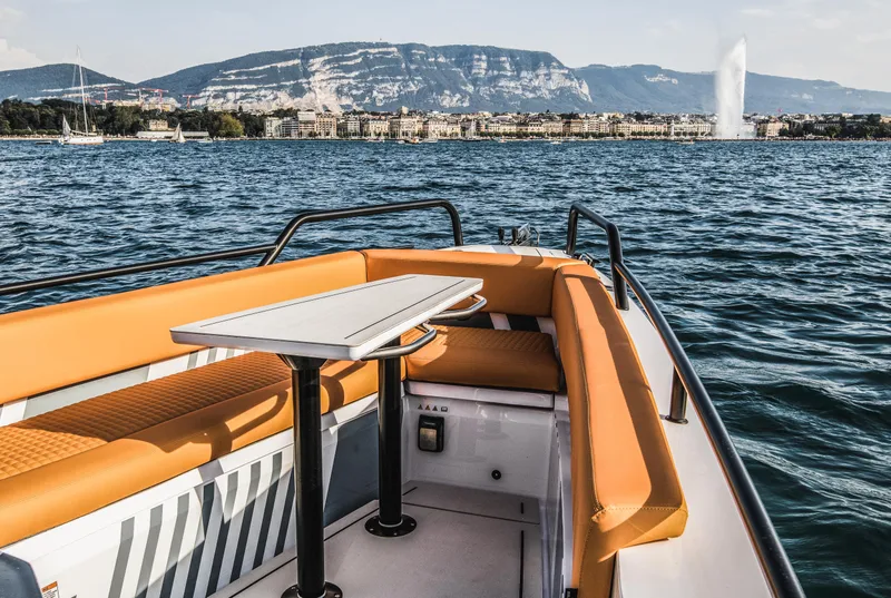 Slide: The Image of 2023 BRABUS Shadow 500 Cabin boat with orange seating on a scenic lake. - 44