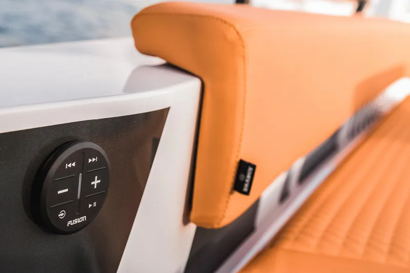 Slide: The Image of Close-up of the 2023 BRABUS Shadow 500 Cabin's orange seating and Fusion audio control. - 46