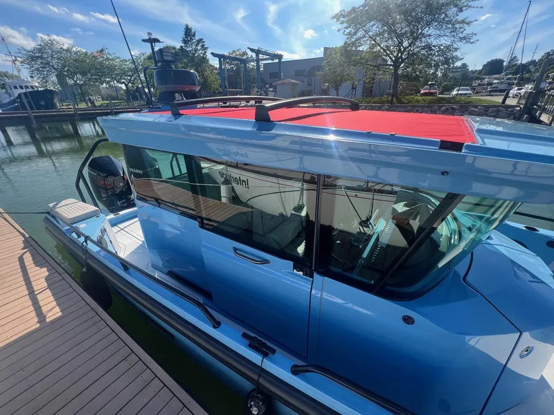 Slide: The Image of 2023 BRABUS Shadow 500 Cabin boat docked at marina on a sunny day. - 5