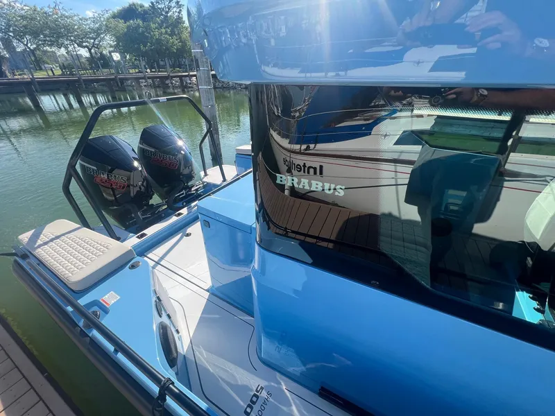 Slide: The Image of 2023 BRABUS Shadow 500 Cabin boat docked with twin outboard engines. - 6