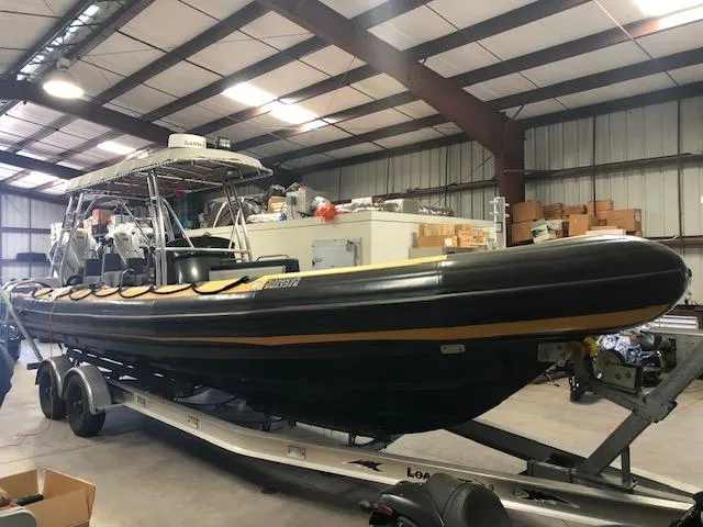 Slide: The Image of 2008 Ribcraft 9.0 boat on trailer in warehouse setting. - 11