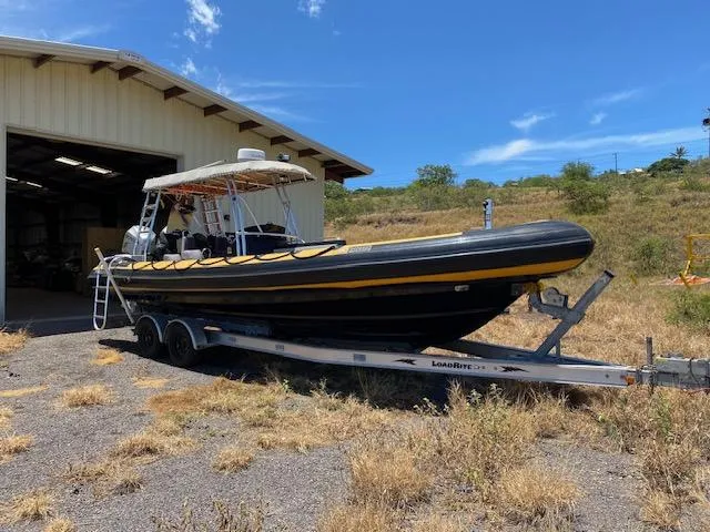 Slide: The Image of 2008 Ribcraft 9.0 boat on trailer outside a storage shed. - 12