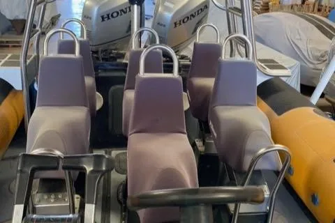 Slide: The Image of 2008 Ribcraft 9.0 boat interior with Honda engines and seating arrangement. - 4