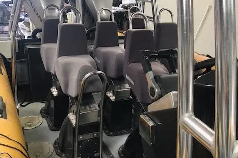 Slide: The Image of Interior of a 2008 Ribcraft 9.0 boat with multiple cushioned seats. - 5