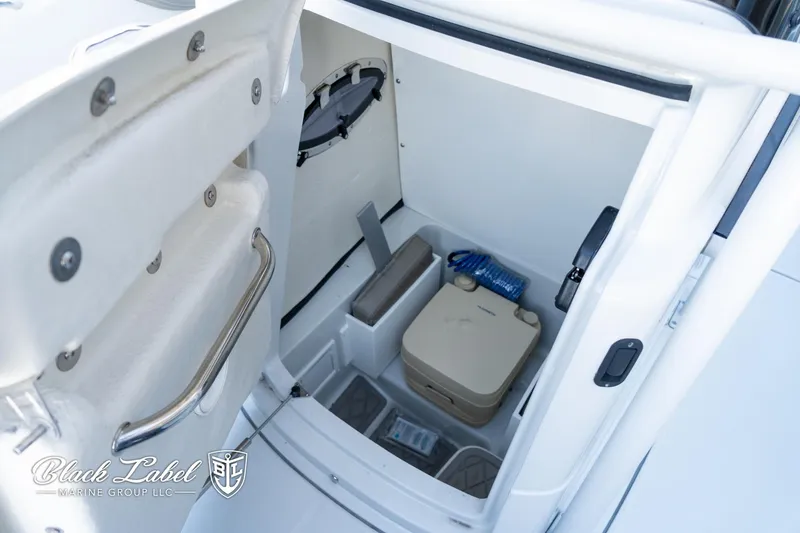 Slide: The Image of 2024 Finseeker 220 FinSeeker boat interior storage compartment with portable toilet and accessories. - 10