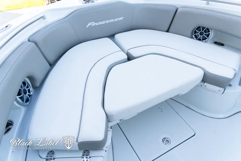 Slide: The Image of 2024 Finseeker 220 FinSeeker boat interior with cushioned seating and speaker system. - 11