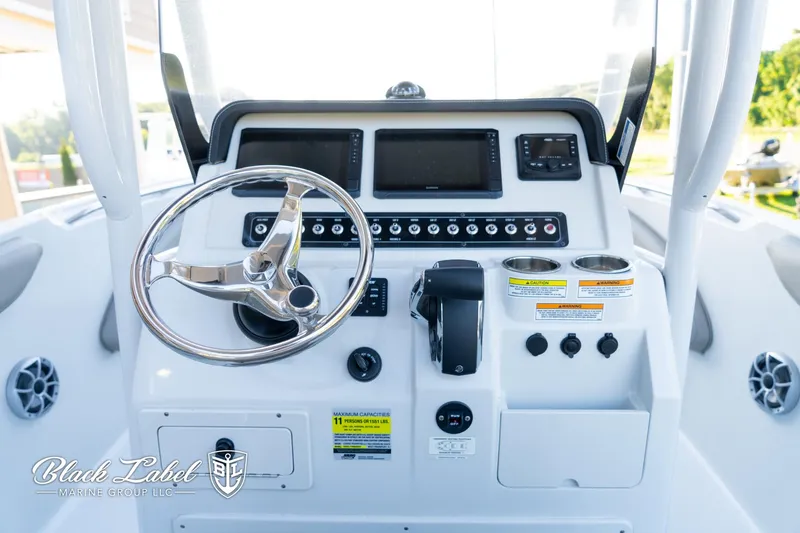 Slide: The Image of 2024 Finseeker 220 FinSeeker boat dashboard with steering wheel and control panel. - 13