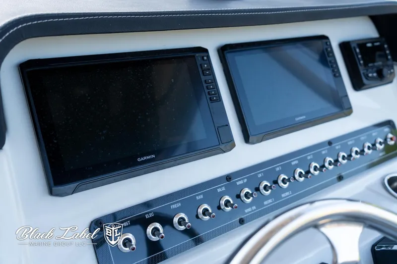 Slide: The Image of 2024 Finseeker 220 dashboard with dual Garmin displays and control switches. - 14