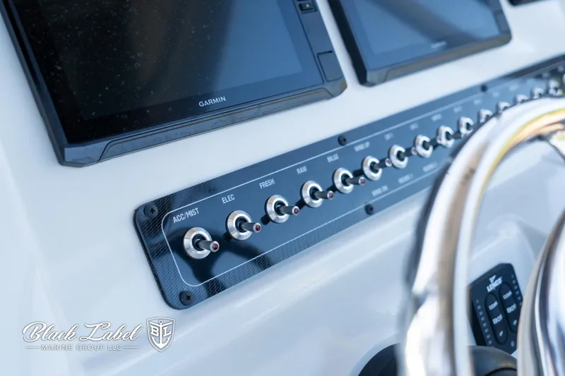 Slide: The Image of 2024 Finseeker 220 FinSeeker dashboard with control switches and Garmin displays. - 15