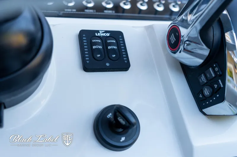 Slide: The Image of 2024 Finseeker 220 FinSeeker boat controls with Lenco trim tab switches. - 18