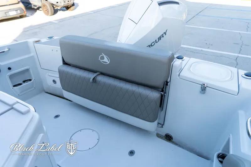 Slide: The Image of 2024 Finseeker 220 boat interior with Mercury engine, featuring gray seating and storage compartments. - 20