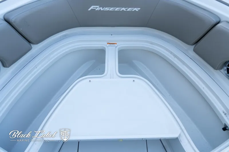 Slide: The Image of 2024 Finseeker 220 FinSeeker boat interior with seating and storage. - 6