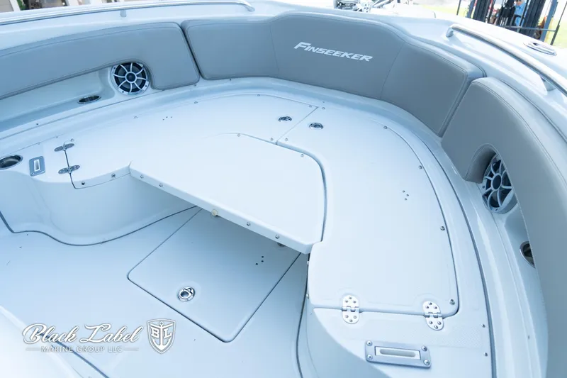 Slide: The Image of 2024 Finseeker 230 FinSeeker boat interior with seating and storage compartments. - 10