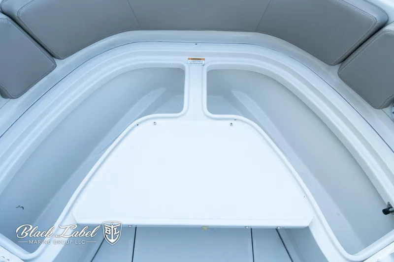 Slide: The Image of 2024 Finseeker 230 FinSeeker boat interior with cushioned seating and storage area. - 11