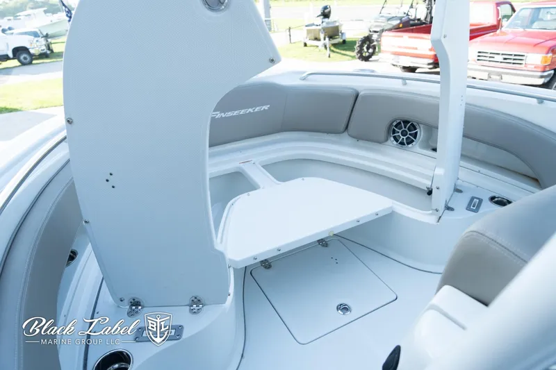 Slide: The Image of 2024 Finseeker 230 FinSeeker boat interior with seating and storage, by Black Label Marine Group. - 12