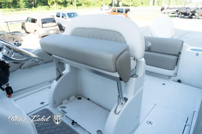 Slide: The Image of 2024 Finseeker 230 boat interior with cushioned seating and steering area. - 17