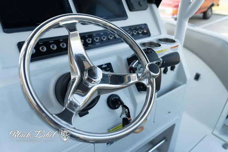 Slide: The Image of 2024 Finseeker 230 FinSeeker boat dashboard with steering wheel and controls. - 20