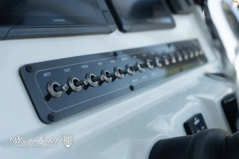 Slide: The Image of Control panel of 2024 Finseeker 230 FinSeeker boat with labeled switches. - 22