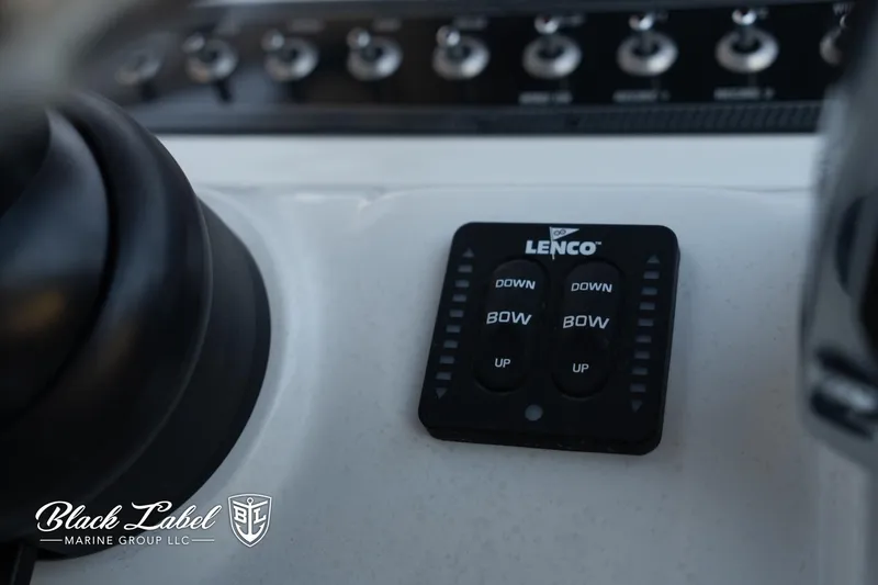 Slide: The Image of Control panel of 2024 Finseeker 230 FinSeeker boat with Lenco trim tab switches. - 23