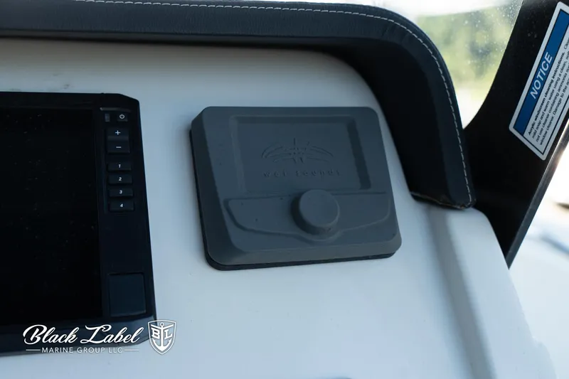 Slide: The Image of 2024 Finseeker 230 dashboard with control panel and Black Label Marine Group logo. - 25