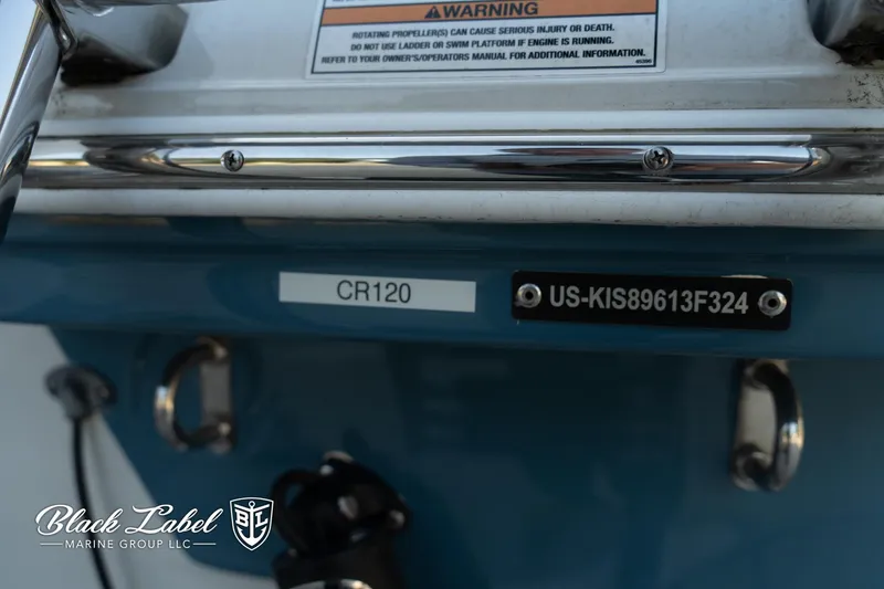 Slide: The Image of 2024 Finseeker 230 boat detail with warning label and identification numbers. - 3