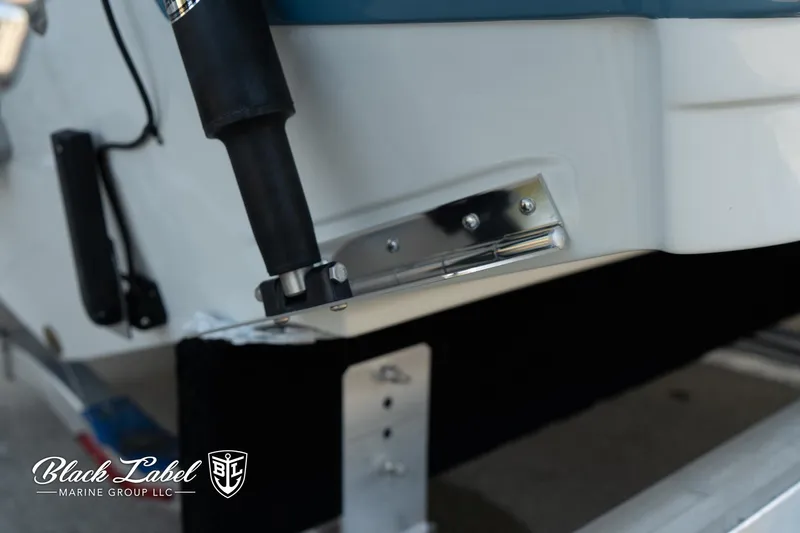 Slide: The Image of 2024 Finseeker 230 boat detail, featuring trim tab and Black Label Marine Group logo. - 7