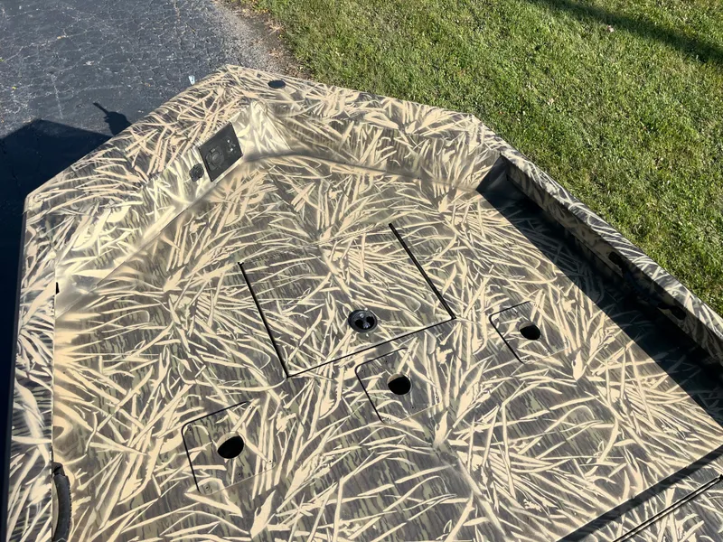 Slide: The Image of 2024 Lowe Outlet 20 boat with camouflage pattern on deck. - 11