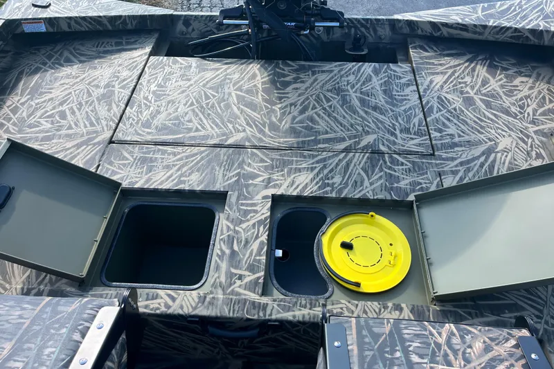 Slide: The Image of 2024 Lowe Outlet 20 boat with open storage compartments and camo pattern. - 15