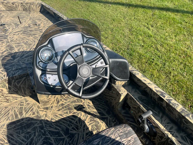 Slide: The Image of 2024 Lowe Outlet 20 boat steering console with camouflage design. - 16