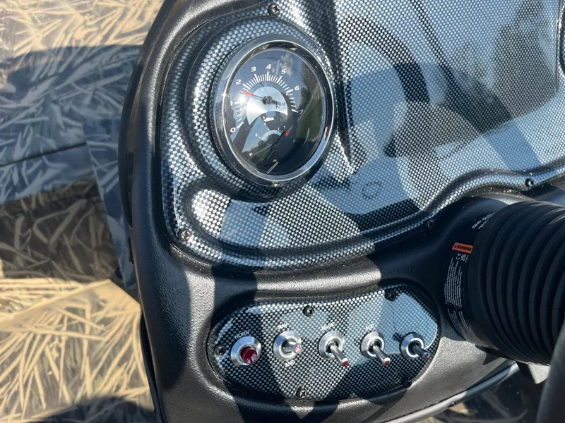 Slide: The Image of 2024 Lowe Outlet 20 boat dashboard with speedometer and control switches. - 18